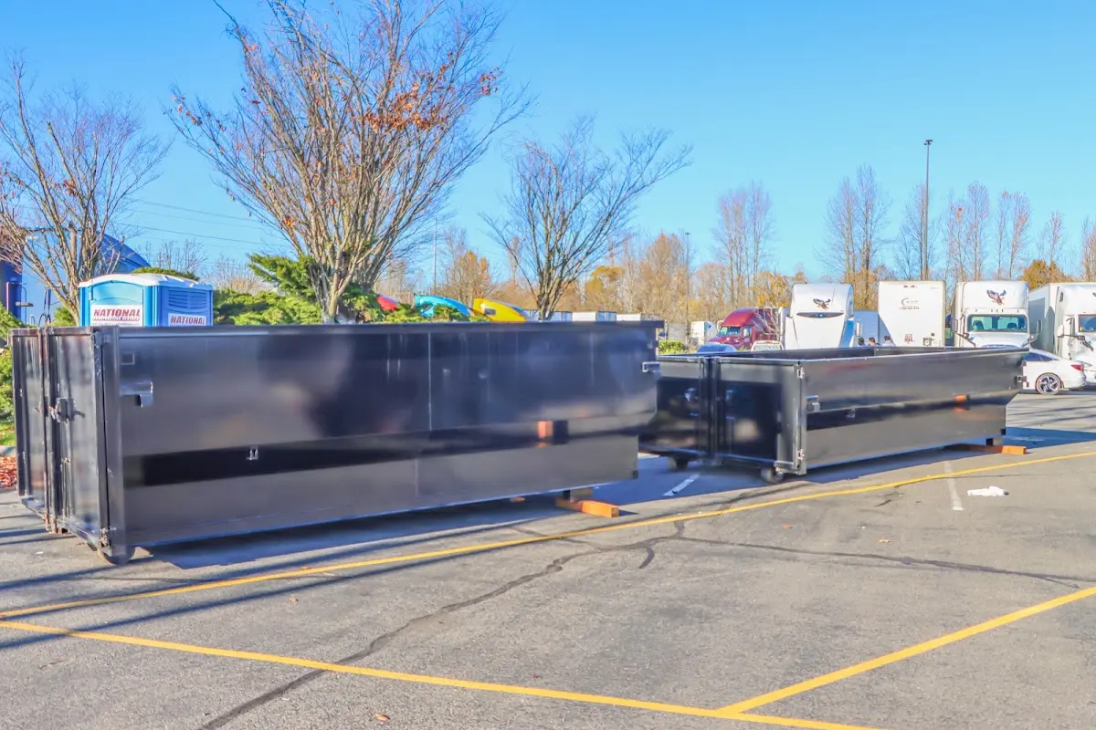 Professional dumpster rental service with roll-off container on residential driveway in Rock Island